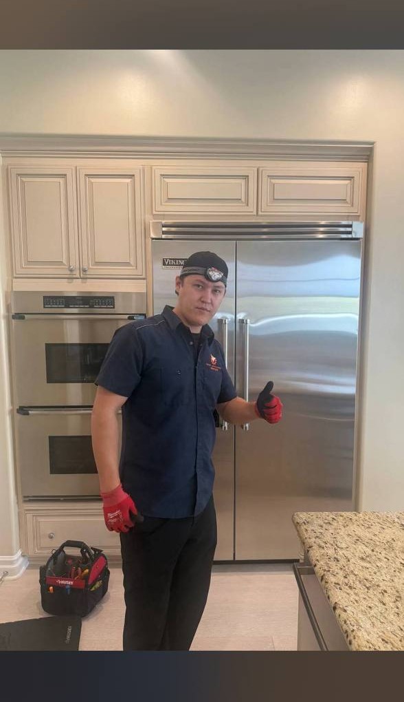 MarkFix technician repairing a front-load washing machine in Los Angeles